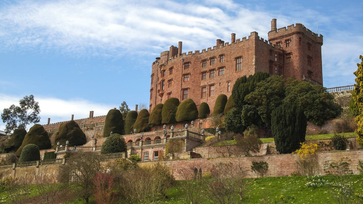 Powis Castle standing on a hill with reddish bricks