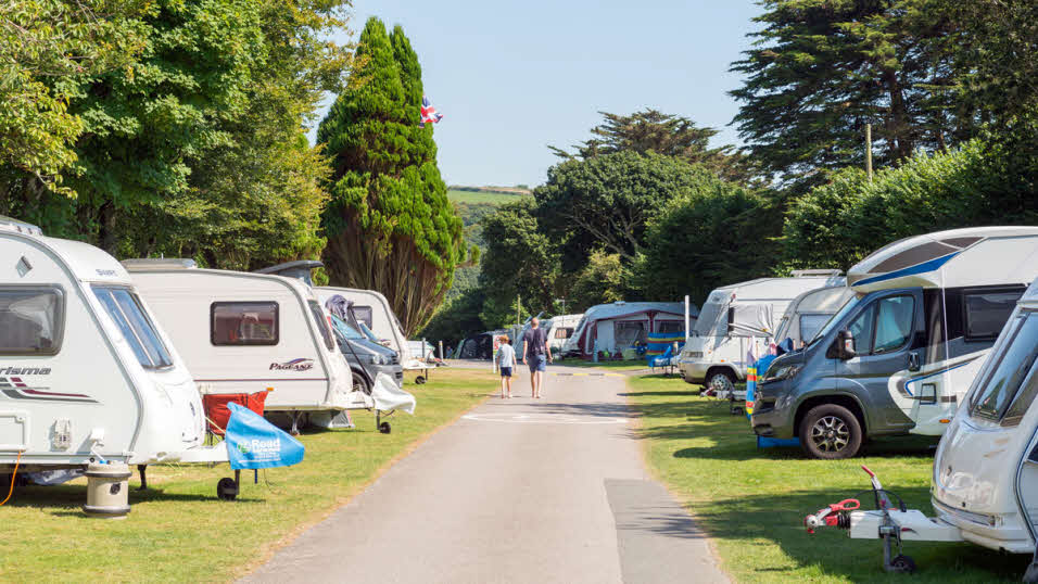 Looe club site caravan and motorhome pitches with children walking through the site